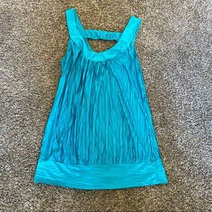 b.wear sleeveless turquoise top -Medium